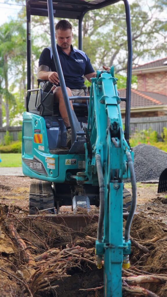 Ben the owner of dream plumbing and gas operating an escuvator digging a trench to locate damaged blocked drain.
Plumber sydney