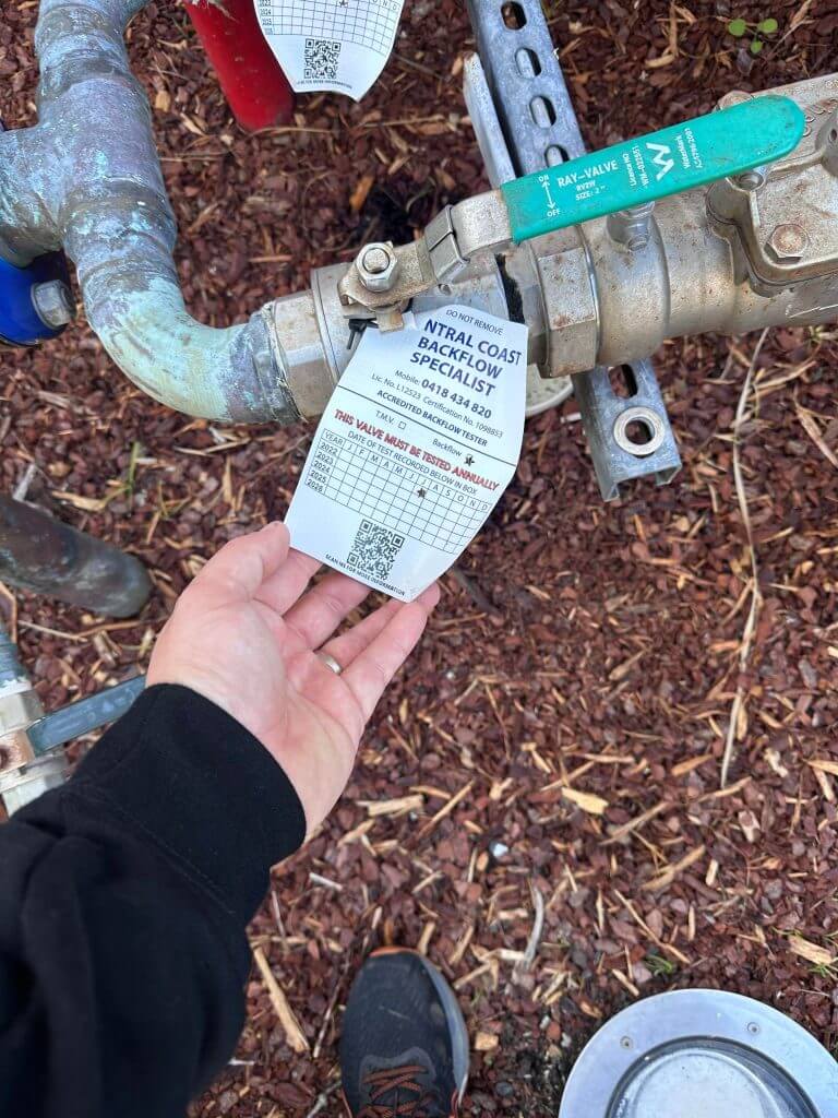 Inspecting the maintenance tag on a Backflow Prevention installation