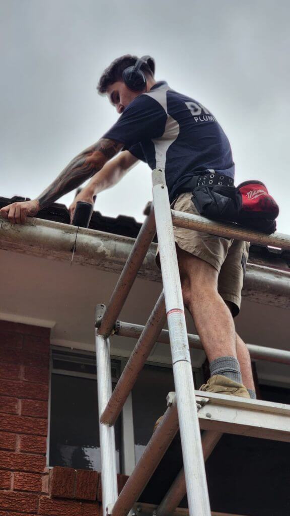 Roof and Gutter Plumber Sydney performing a gutter inspection for a client